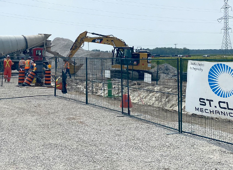 Civil job site with excavator and cement truck